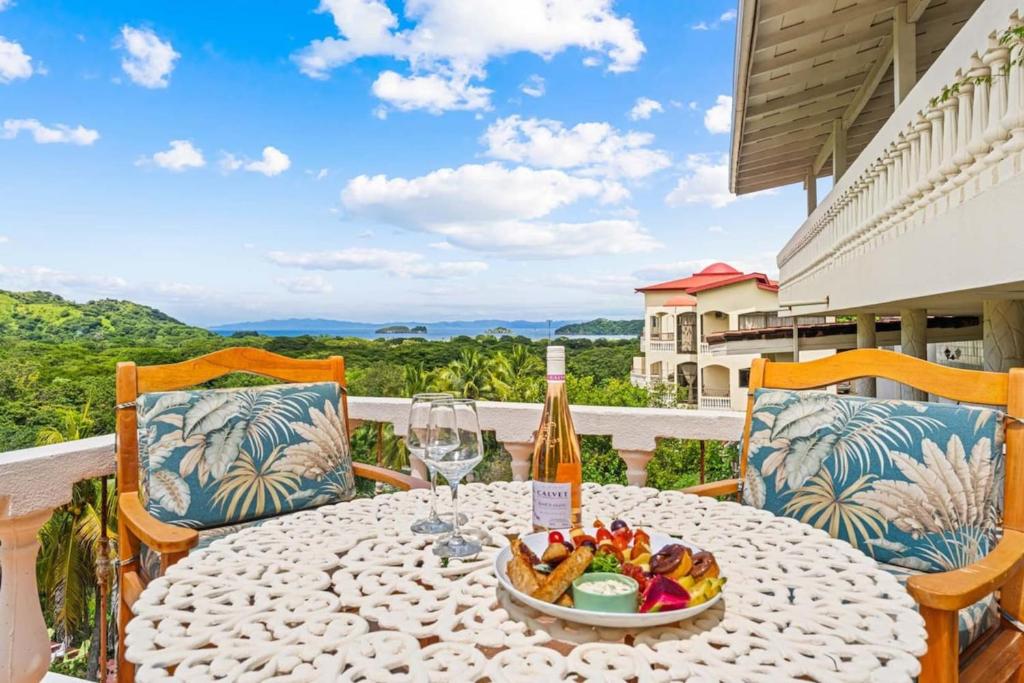 a table with a bowl of fruit and a bottle of wine at Outstanding & Huge 600m Private Villa - Pool - BBQ in Coco