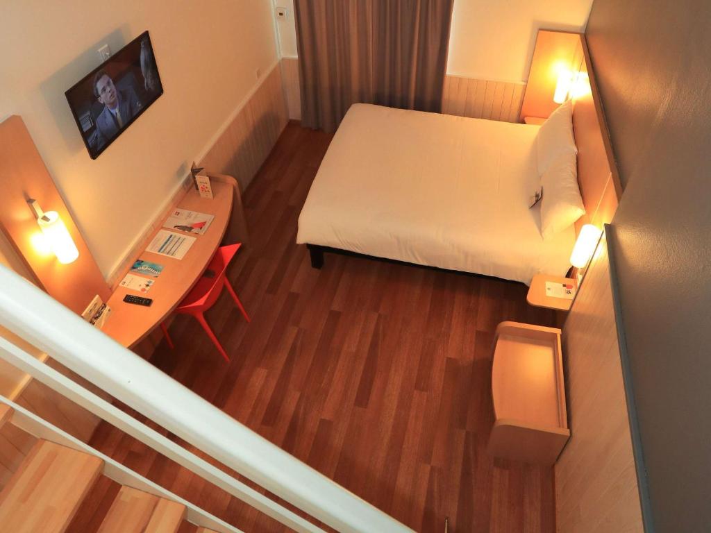 Postel nebo postele na pokoji v ubytování ibis Aurillac