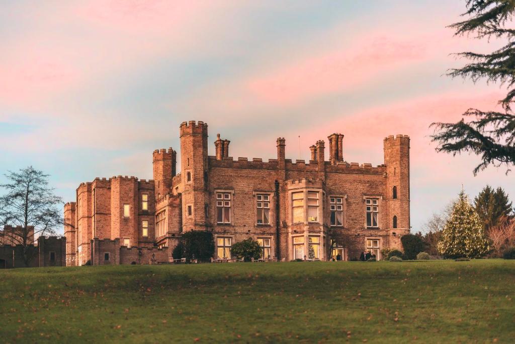 an old castle on top of a grassy field at Cave Castle Hotel in South Cave