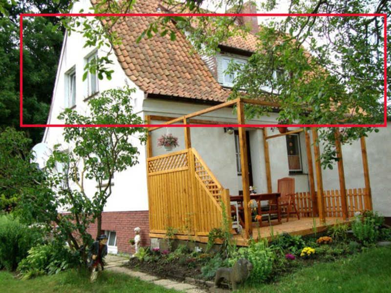 a picture of a house with a porch with a deck at Ferienwohnung "Kleine Sandburg" in Heiligendamm