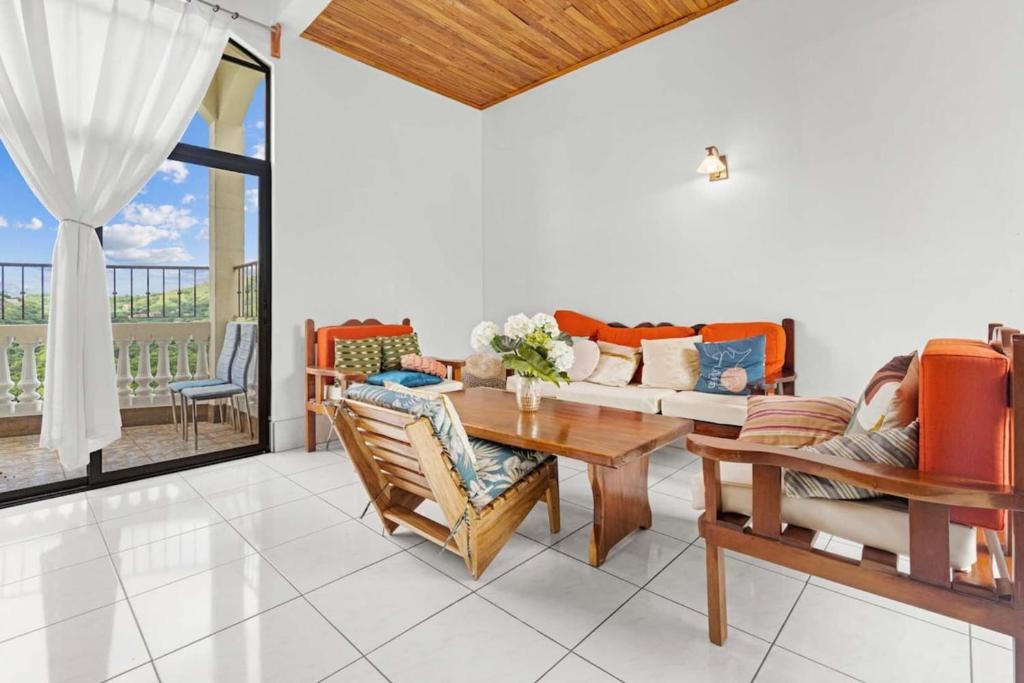 a living room with a table and a couch at Amazing PenthouseL 5 min from Coco Beach in Coco