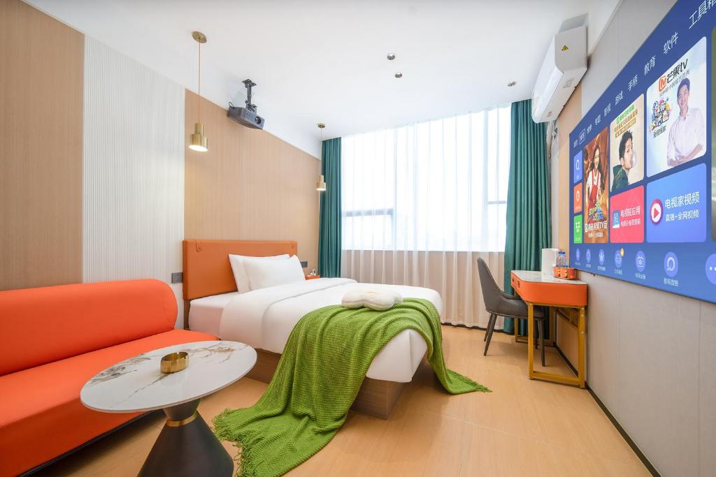 a hotel room with a bed and a couch at Guangzhou Yashe Hotel - Keyun Road Metro Station Pazhou Convention and Exhibition Store in Guangzhou