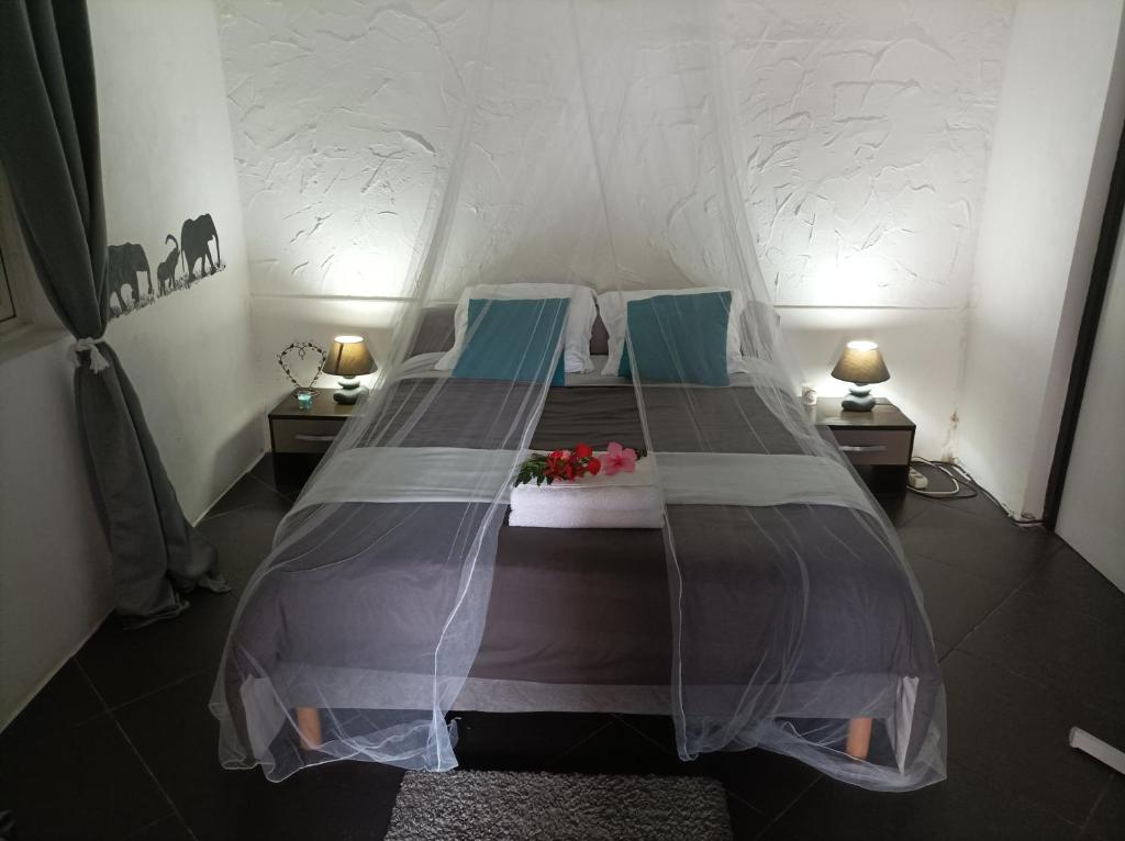 a bedroom with a bed in a tent at TI KAZ PIROGUE in L'Étang-Salé les Bains