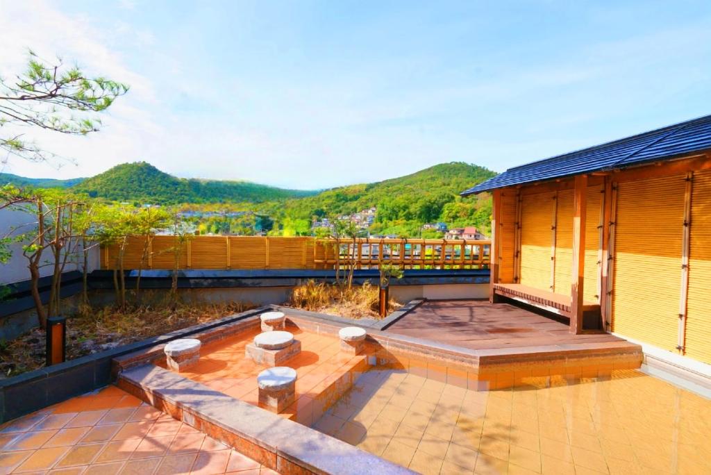 a house with a patio with a view of the mountains at Arimakan in Kaminoyama