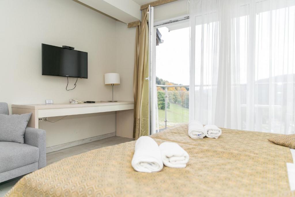 ein Hotelzimmer mit einem Bett mit Handtüchern darauf in der Unterkunft VacationClub - Solden Apartament 33 in Heudorf