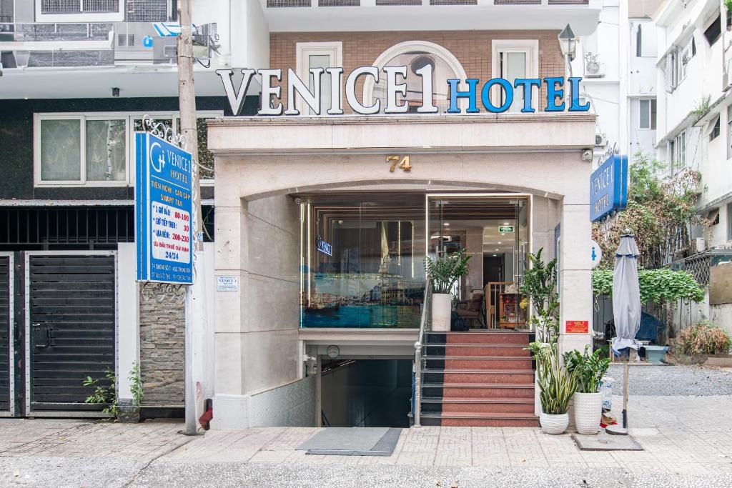 a venice hotel with a sign on a building at Venice 1 Hotel in Ho Chi Minh City