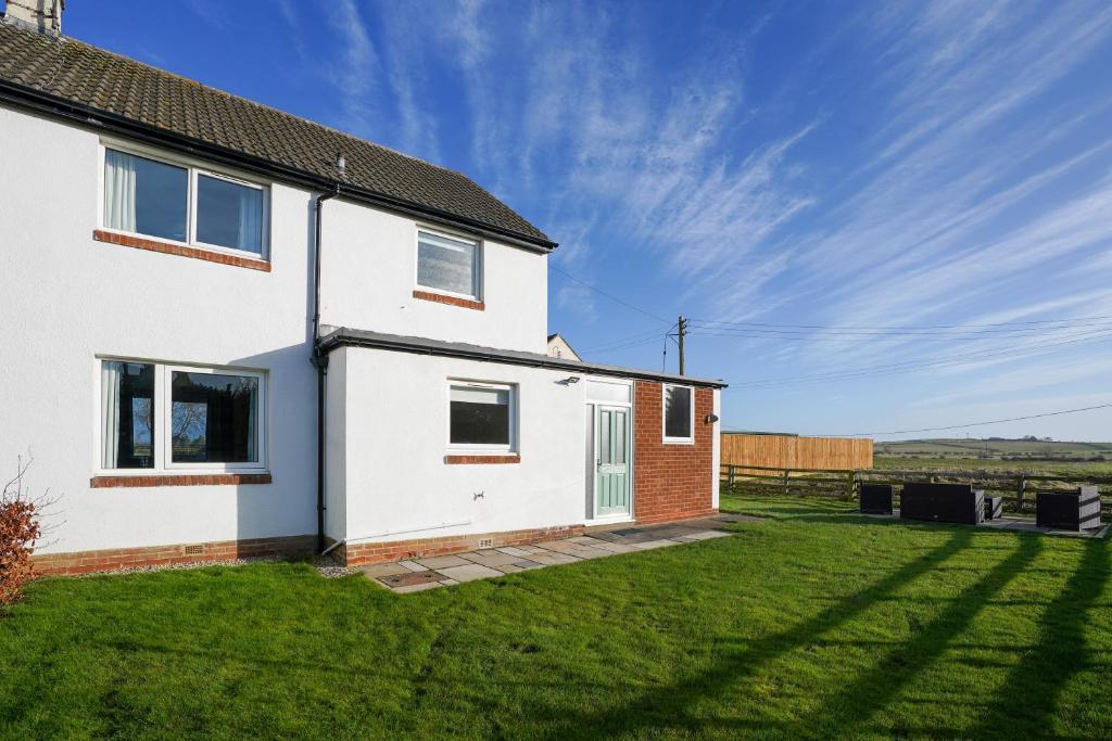 a white house with a large yard at The Birdhouse Family Home with Countryside Views in Beal