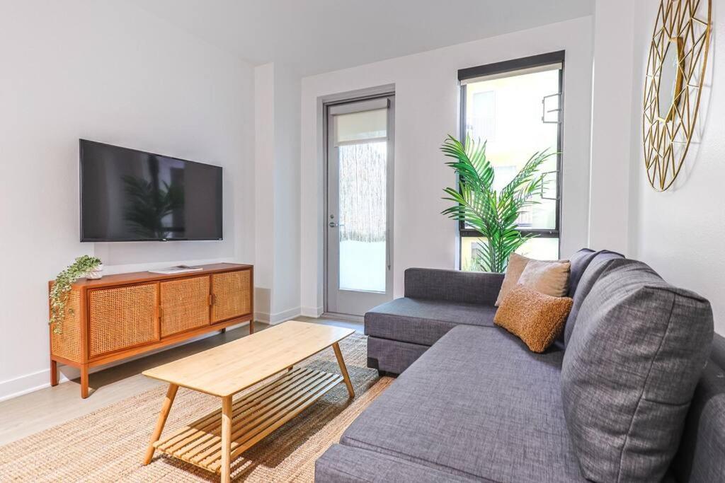 a living room with a couch and a tv at Stylish & Cozy 2BDR & 2BTH in SM with Balcony for 6 pax in Los Angeles