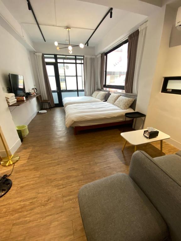 a living room with a couch and a table at One Day 有日-民生路一段207號 in Tainan