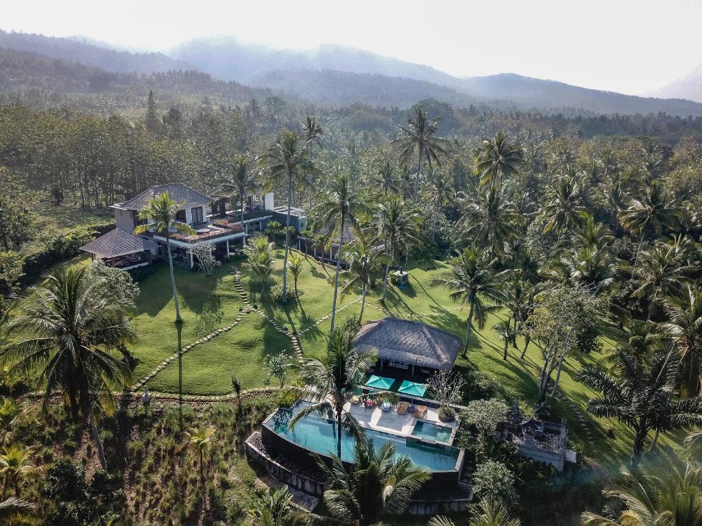 an aerial view of a resort with palm trees at Villa Palem in Tabanan