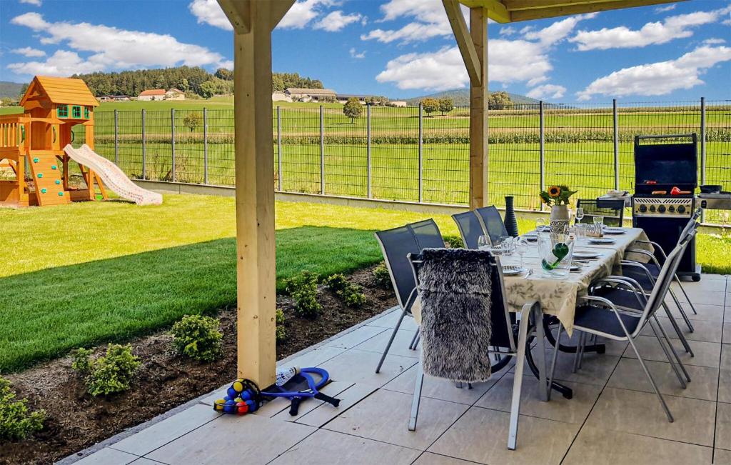 a table and chairs on a patio with a playground at 4 Bedroom Lovely Home In Klaffer Am Hochficht in Klaffer am Hochficht