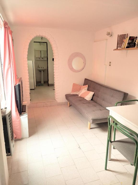 a living room with a couch and a tv at Lugar de descanso LA JESUSA in Playa Unión