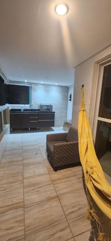 a living room with a couch and a table at Apto Novo no Canto do Forte PG in Praia Grande