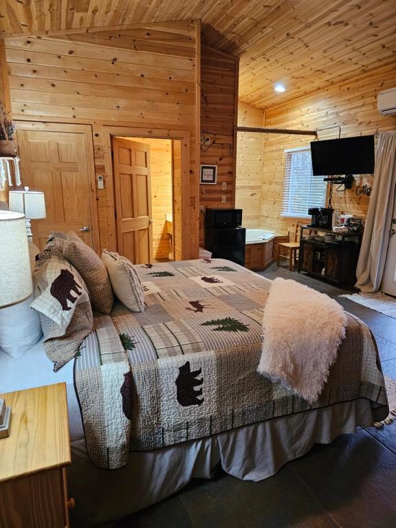 a bedroom with a bed in a log cabin at Honey Bear Haven Suite 5 in Eureka Springs