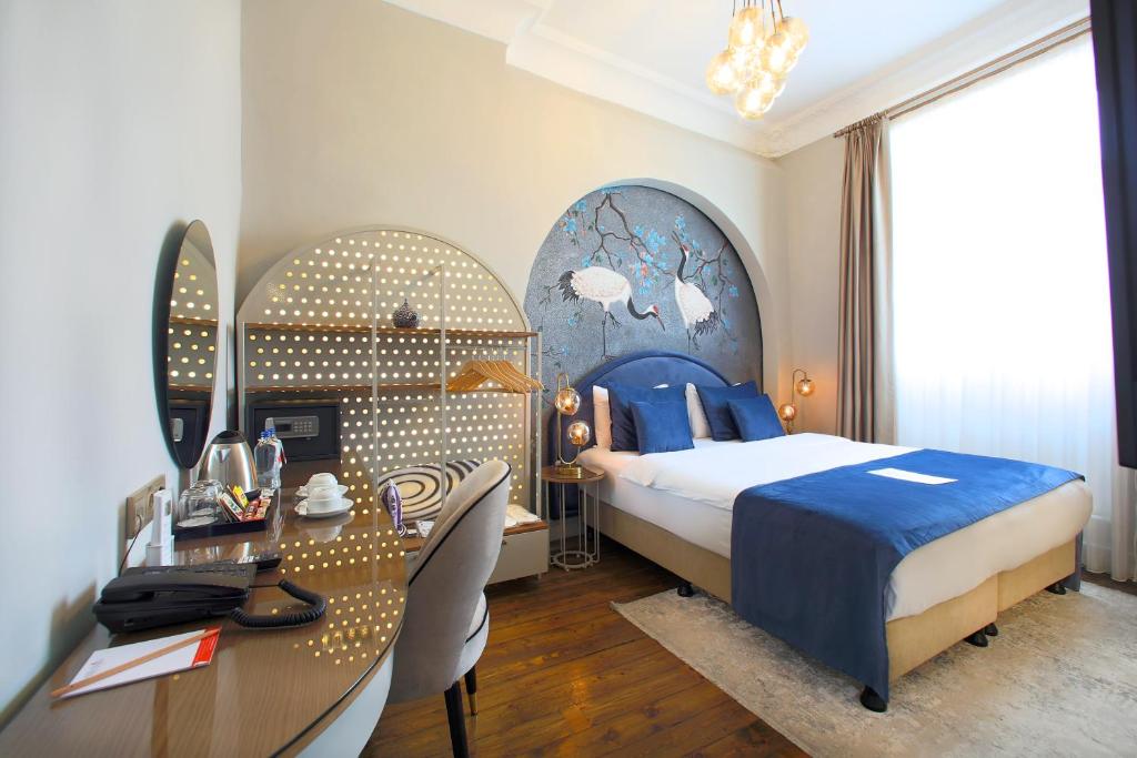 Pokój hotelowy z łóżkiem, biurkiem i stołem w obiekcie Ayramin Exclusive Hotel - Special Category w Stambule