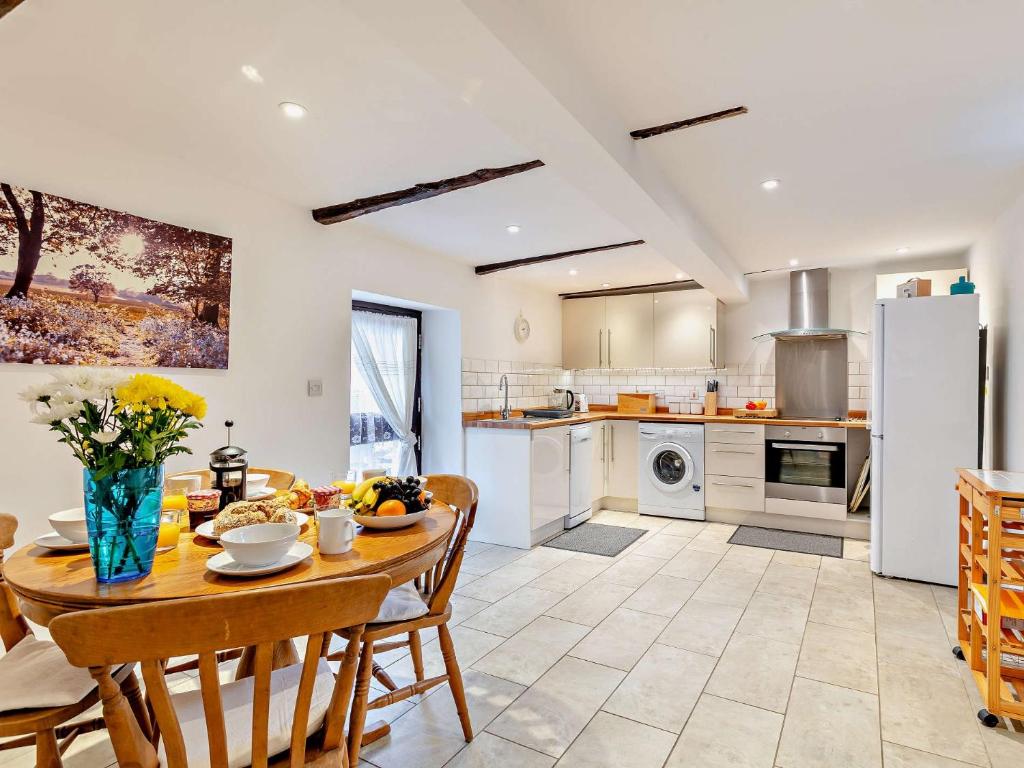 a kitchen and dining room with a table and chairs at 2 bed in Barnstaple 28959 in Chapelton