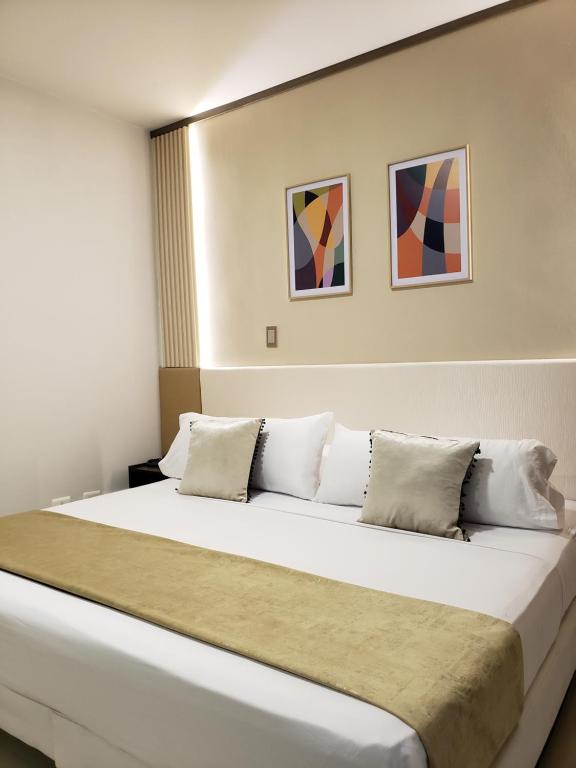 Postel nebo postele na pokoji v ubytování Hotel Suite Center Pereira