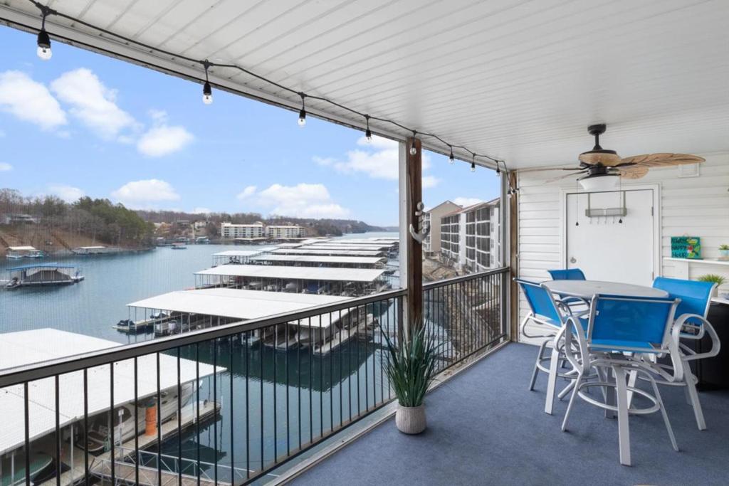 a balcony with a table and chairs and a view of a marina at Lake Ozark Vista in Lake Ozark