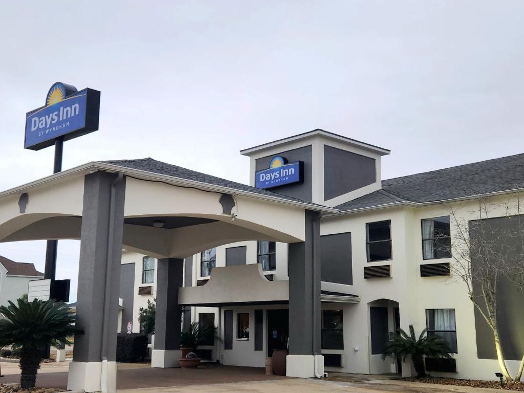 a hotel with a sign on top of it at Days Inn by Wyndham Lafayette Scott in Lafayette