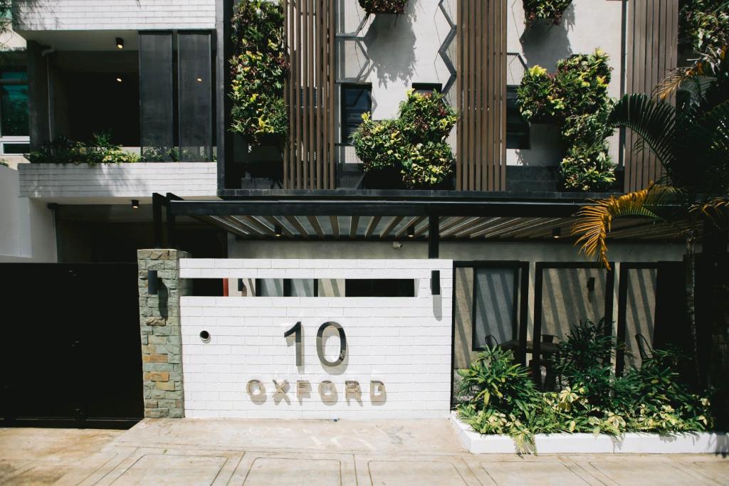 a building with a sign that reads overhead at 10 Oxford Residences in Quezon City