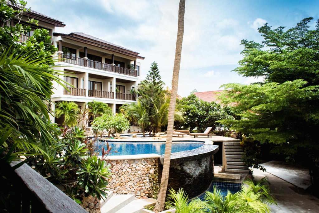a house with a swimming pool and a resort at Panya Samui in Choeng Mon Beach