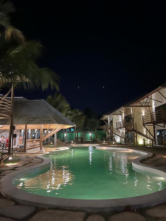 a swimming pool at night with the lights on at AMARE Condomínio ap 103 in Barra Grande