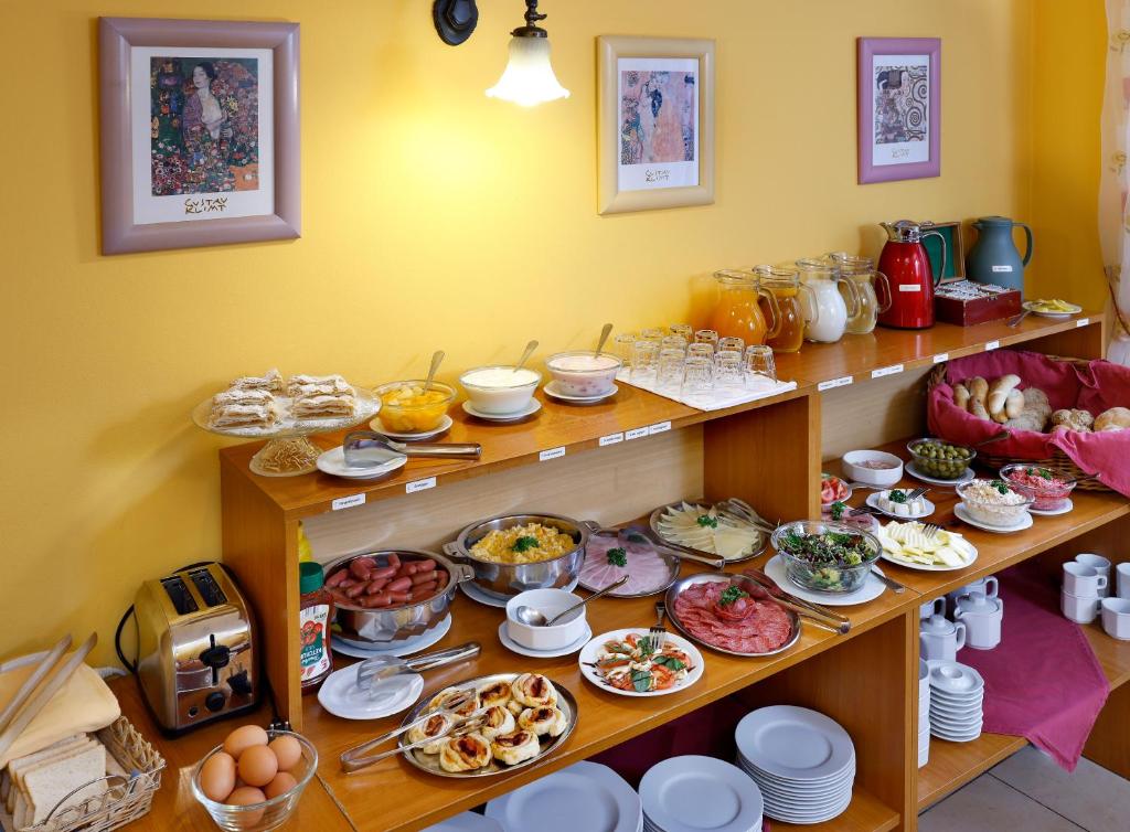 a room with many plates of food on shelves at Hotel Boston in Karlovy Vary