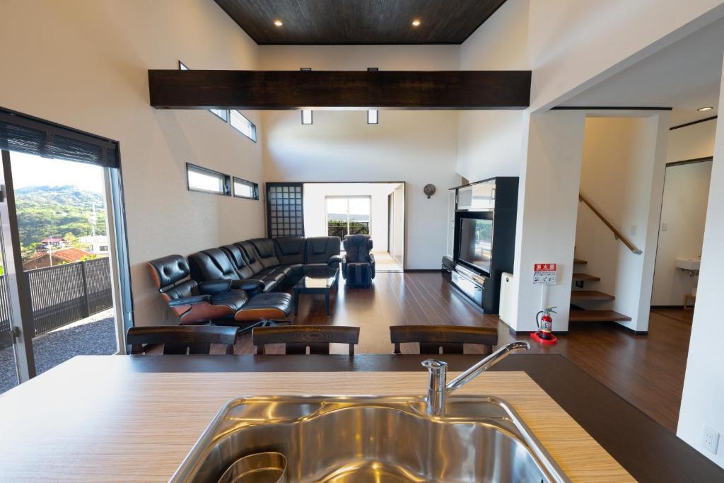 a kitchen with a sink and a living room at Twilight Hills - Vacation STAY 32702v in Motobu