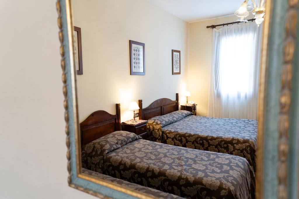 Postel nebo postele na pokoji v ubytování Hotel Tivoli