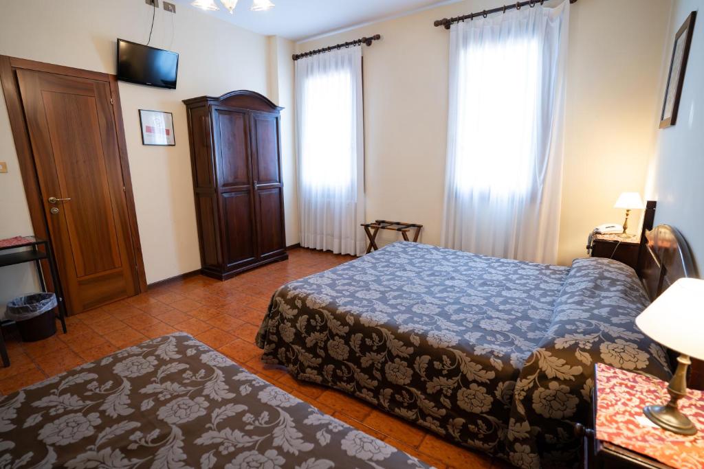 Postel nebo postele na pokoji v ubytování Hotel Tivoli