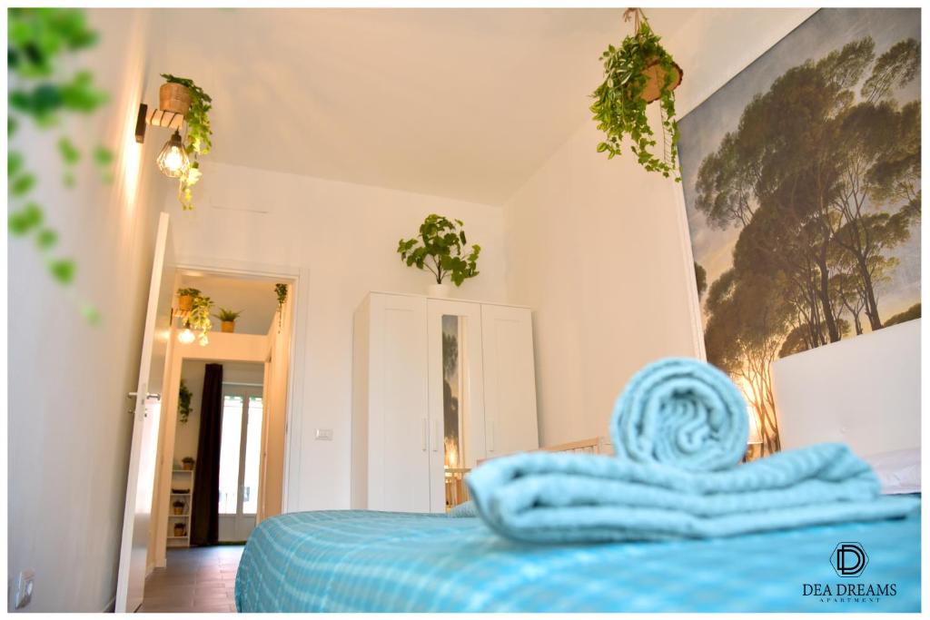 a bedroom with a bed with a blue blanket at DEA DREAMS Amendola Fiera Apartment Free Wi-Fi in Milan