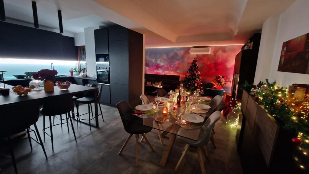 a dining room with a table and christmas decorations at La stanza degli abeti blu in Rome