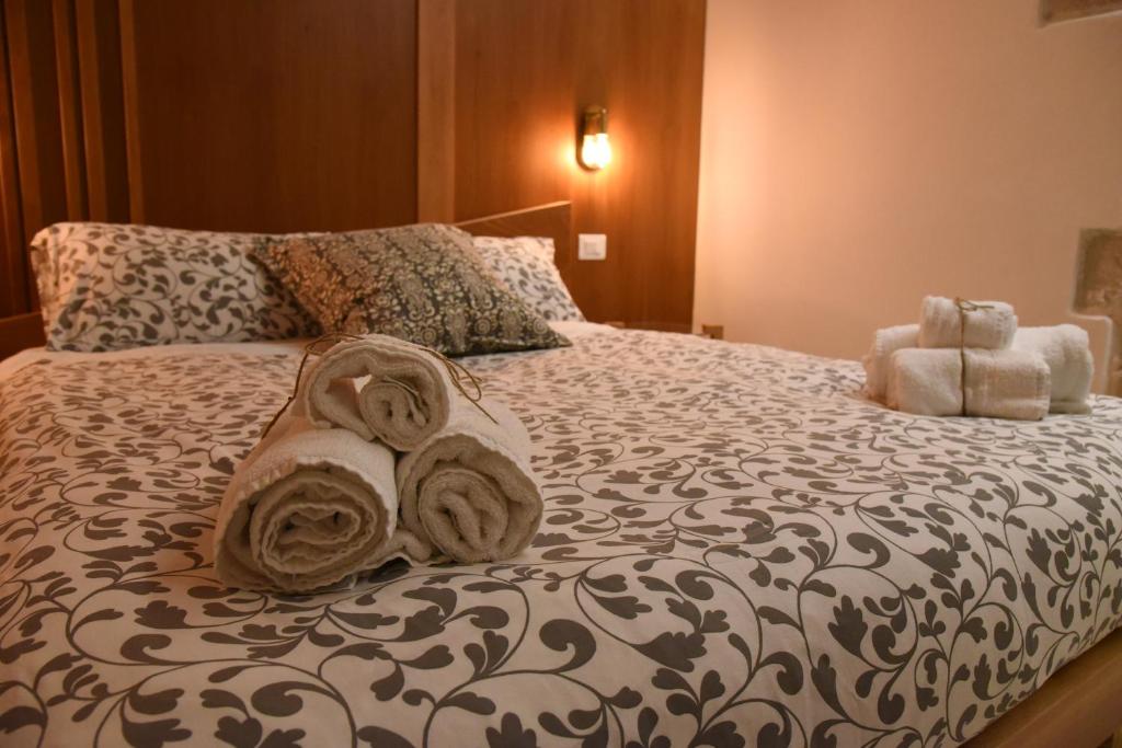 a bedroom with a bed with towels on it at Altemura Suites in Bari