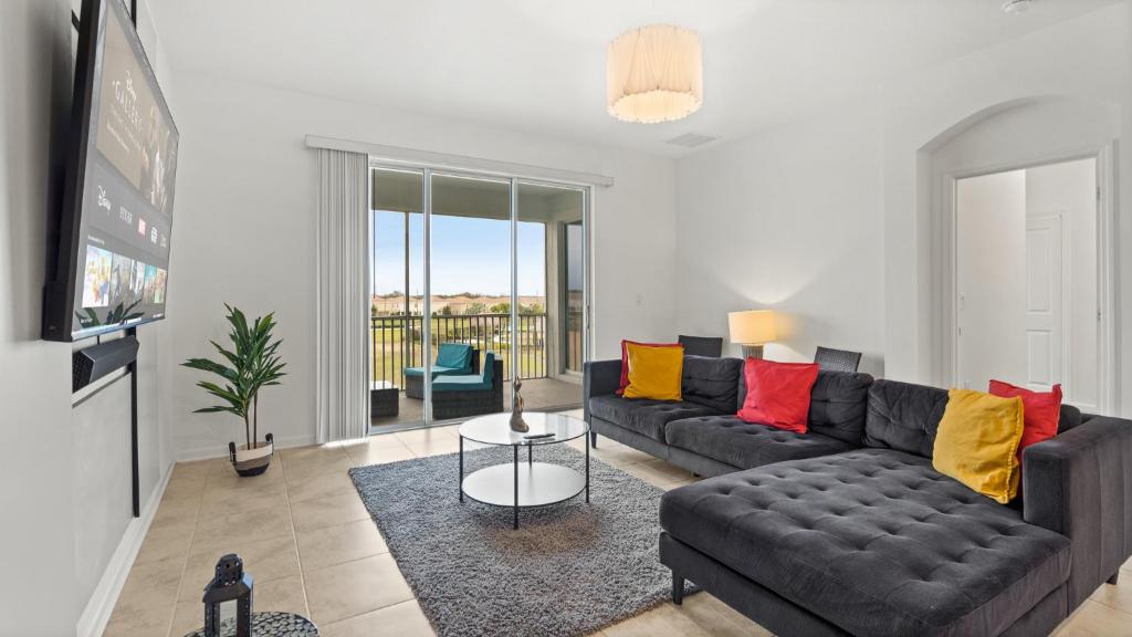 a living room with a couch and a table at Stylish Condo 3Beds 2Baths 18Min from Disney in Kissimmee