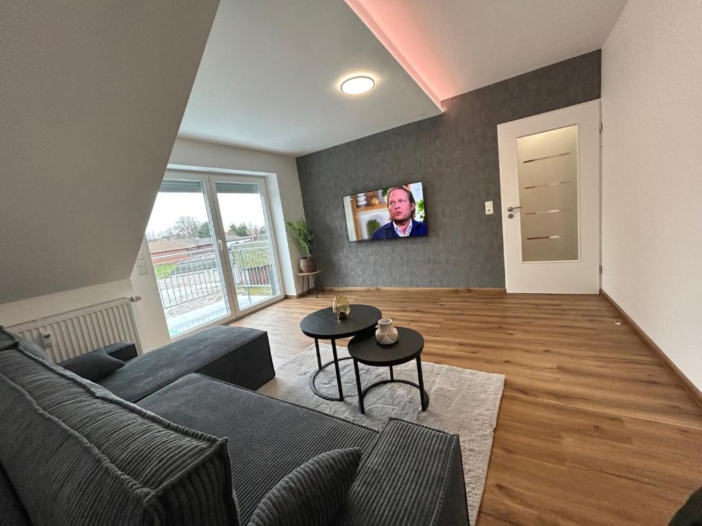 ein Wohnzimmer mit einem Sofa und einem TV in der Unterkunft Apartment Lori in Mönchengladbach