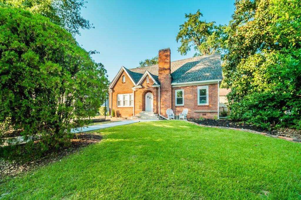 a brick house with a lawn in front of it at Bungalow in the Heart of Heathwood in Columbia