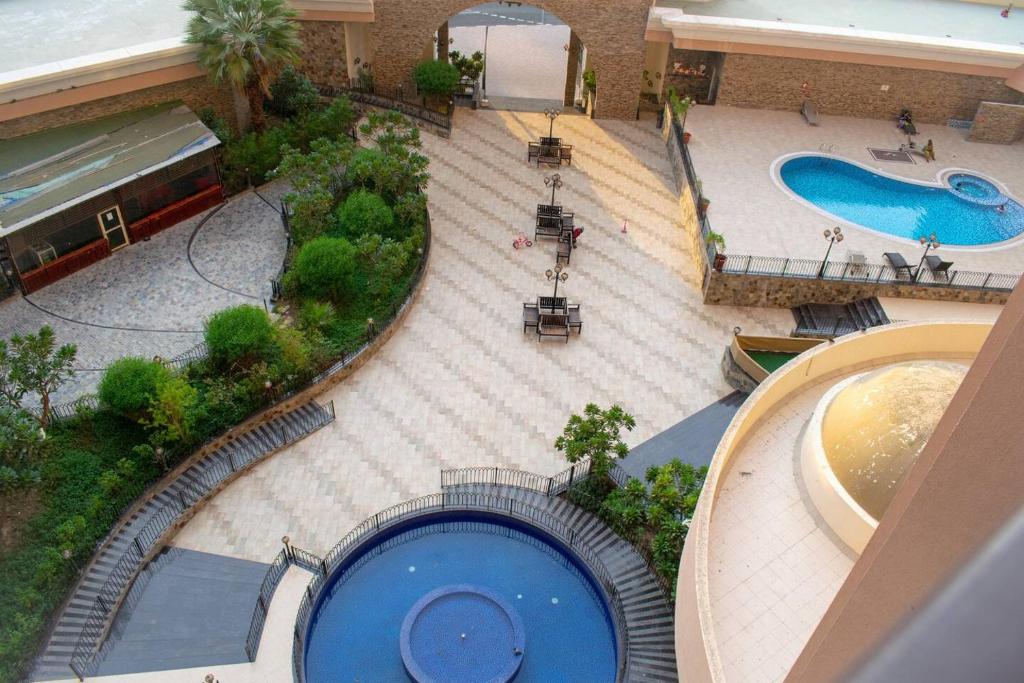 an overhead view of a swimming pool in a mall at Your Silicon Oasis Escape-1bhk in Dubai