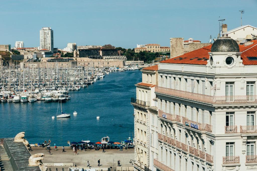 a view of a river in a city with boats at Escale Oceania Marseille Vieux Port in Marseille