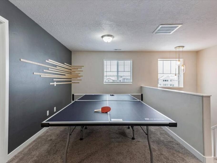 - une table de ping-pong dans une pièce vide avec une table de ping-pong dans l'établissement Pet Friendly, Fully Fenced & Grass Backyard, à American Fork