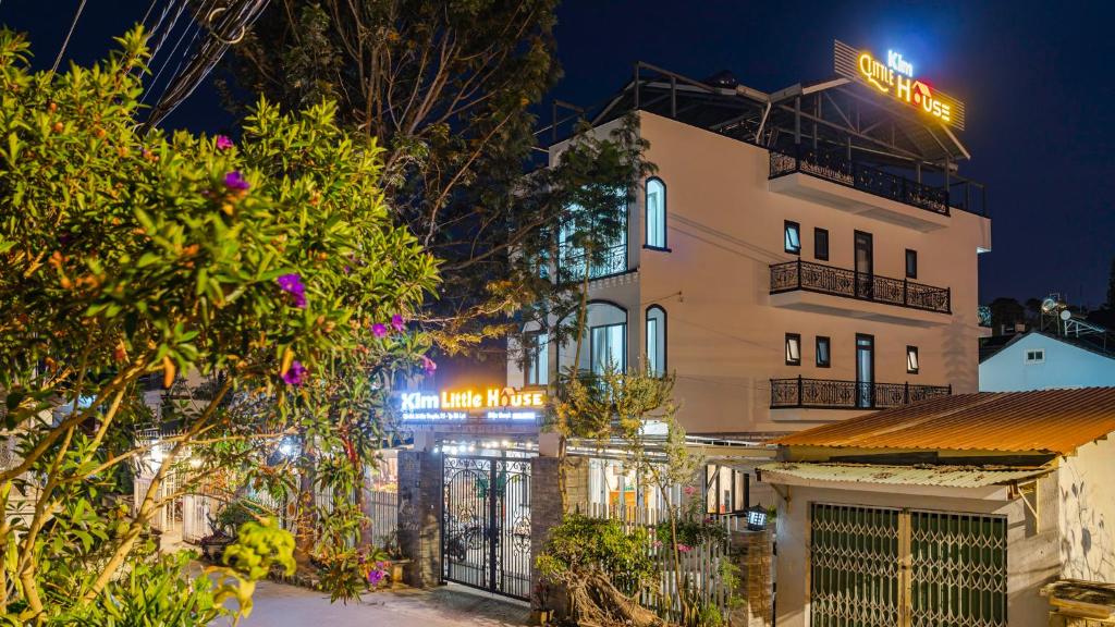 a building with a sign on top of it at night at Kim Little House Hotel in Da Lat