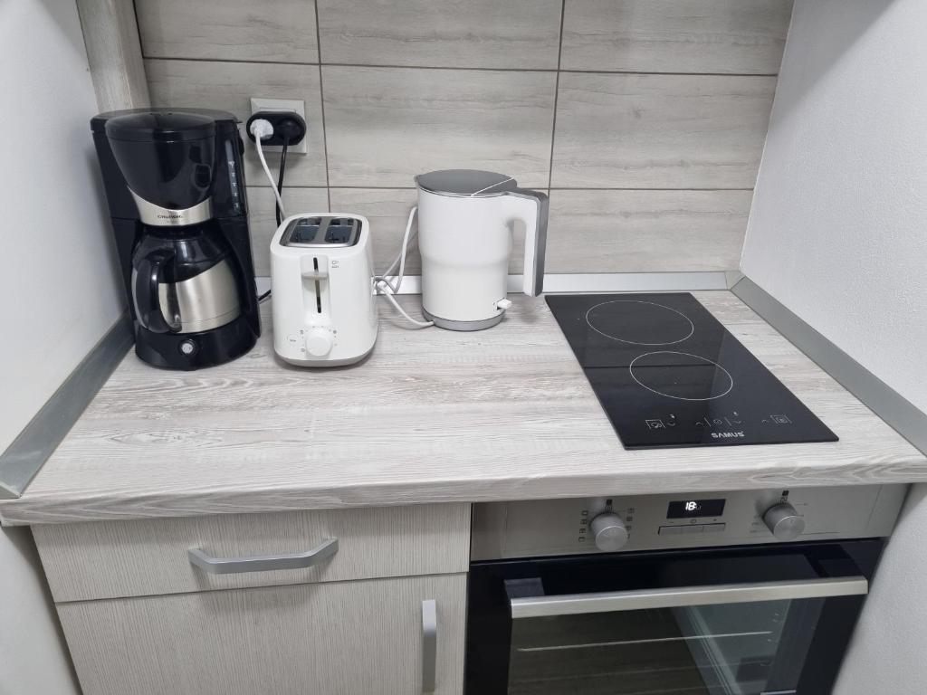 a kitchen counter with a blender and a coffee maker at Garage studio in Bistriţa