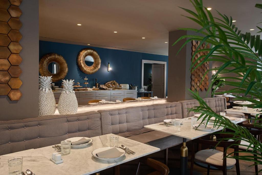 a restaurant with two tables and a counter at Sant Jaume Design Hotel in Palma de Mallorca