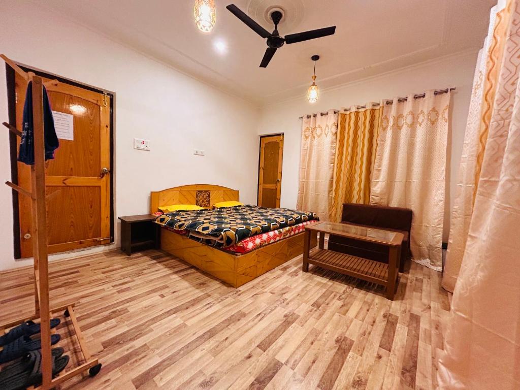a bedroom with a bed and a ceiling fan at John's Homestay in Srinagar
