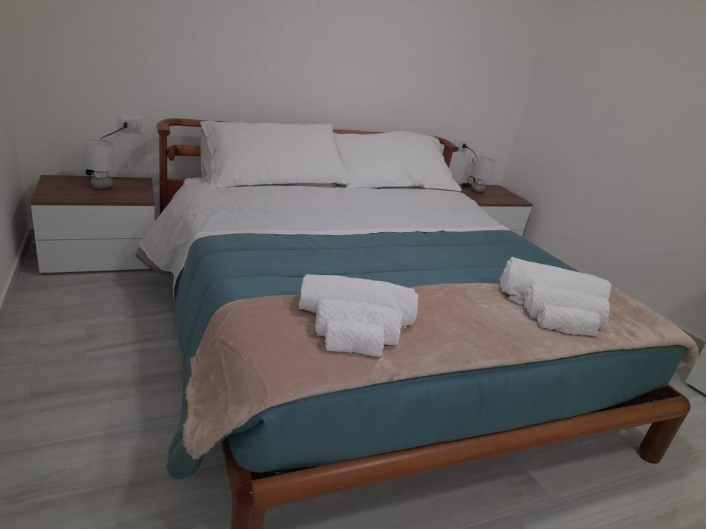 a bedroom with a bed with two pillows on it at Casa vacanze in centro! in Caltagirone