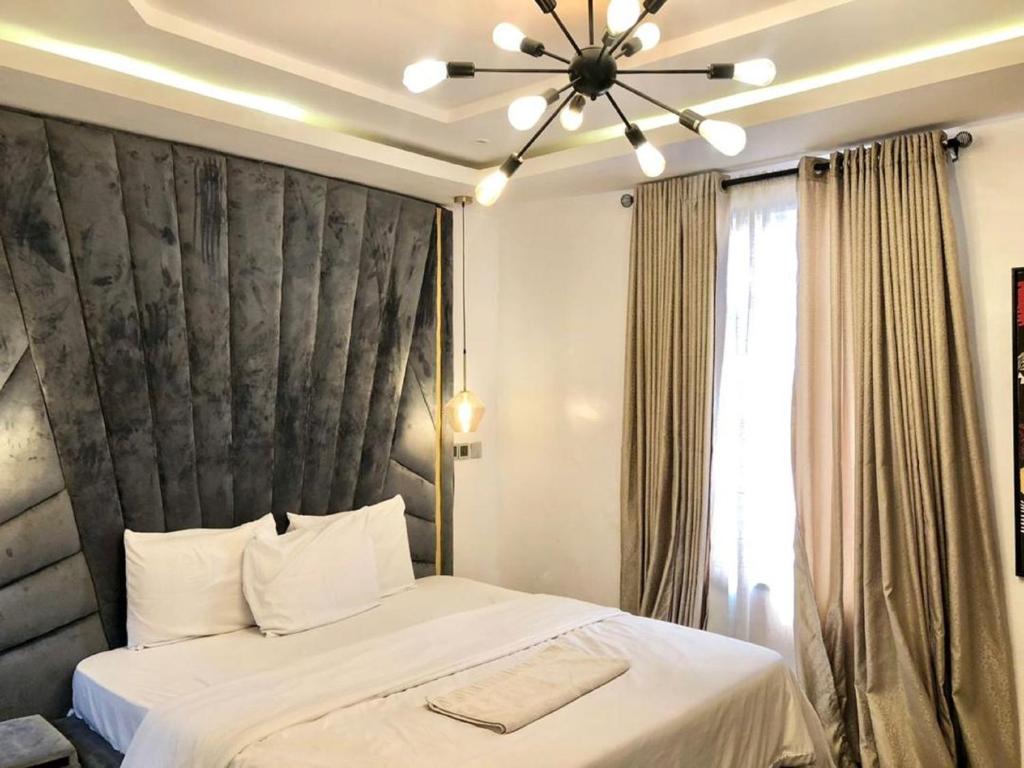 a bedroom with a large bed with a black headboard at 3 Bedroom Luxury Apartment in Lekki in Lagos