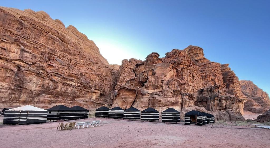 a group of tents in front of a mountain at Celestial Camp Wadi Rum in Wadi Rum
