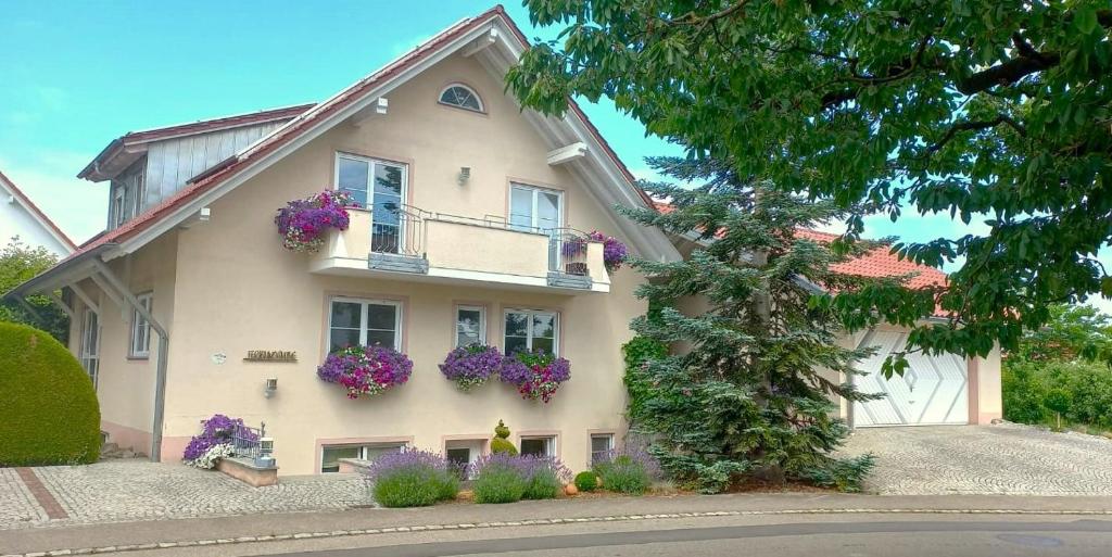 une maison avec des fleurs sur le côté dans l'établissement BodenSEE Apartment Tettnang HOPFENTRAUM, à Tettnang