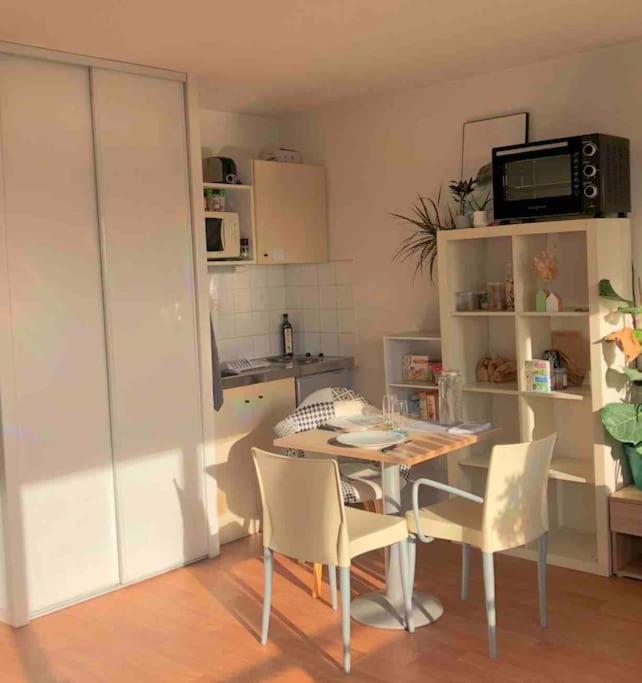 cocina con mesa y sillas en una habitación en Superbe Appartement Lumineux en Rennes