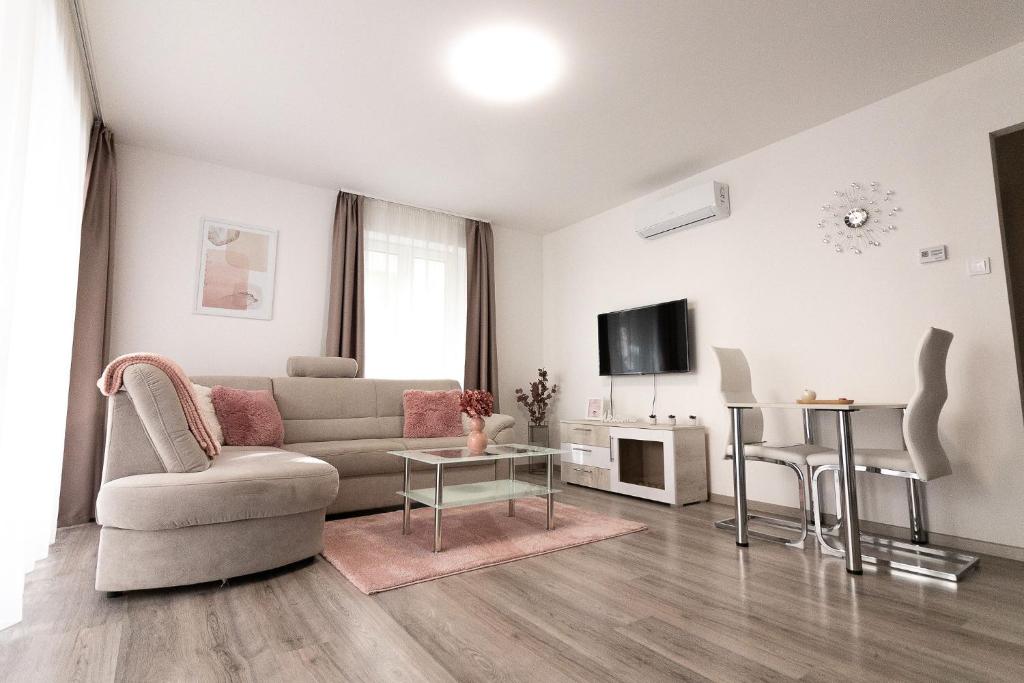 a living room with a couch and a table at SunSuite Szeged in Szeged