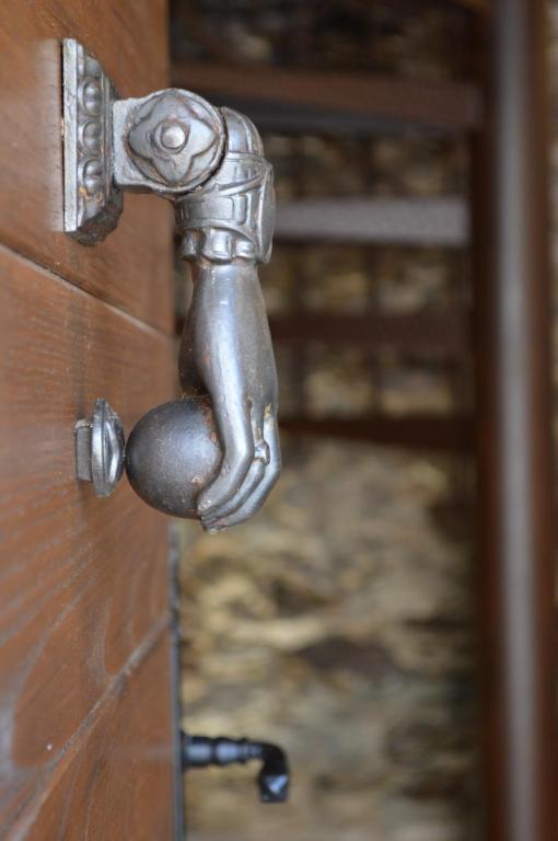 une poignée de porte métallique sur une porte en bois dans l'établissement CASA SANTOLINI, à Poggio-Mezzana